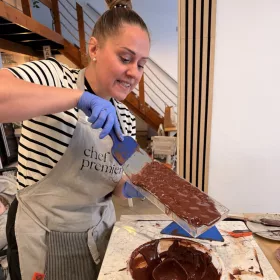 Renée temperált csokoládéval tölti a bonbonformát – csapatépítő bonbon készítés